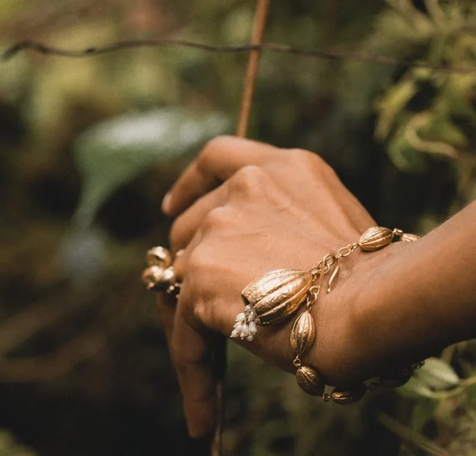 Cocoa pod bracelet and rings worn among leaves, cocoa pod jewellery